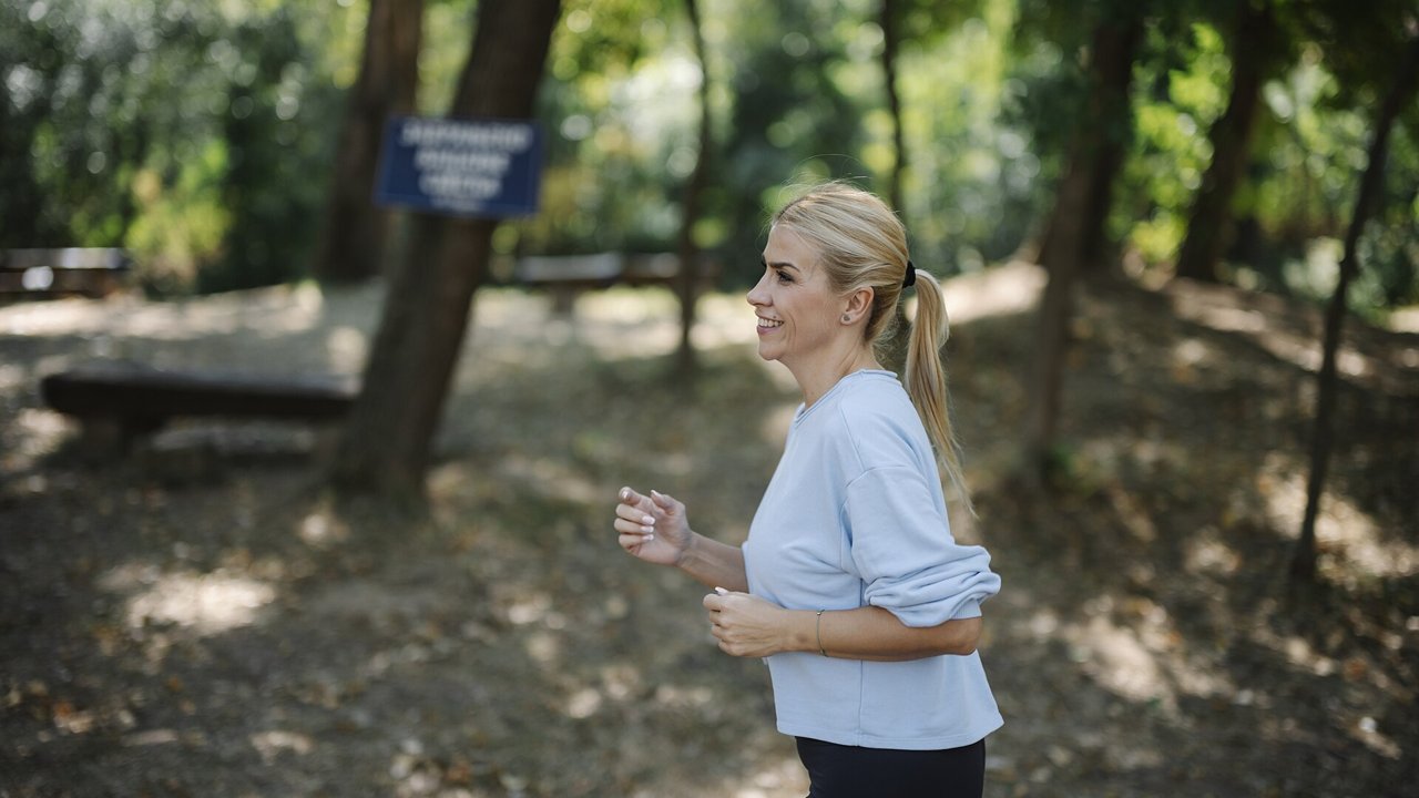 Woman exercising outdoors in a park on a sunny day